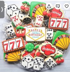 decorated cookies in the shape of casino cards and dices are arranged on a plate