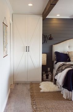 a bedroom with a bed, dresser and pictures on the wall