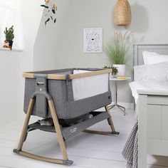 a grey baby crib in a white bedroom