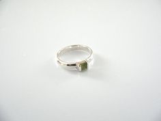 Overview:Offered for sale is a wonderful Tiffany and Co. Sterling Silver Peridot Green Gemstone stacking ring.   Looks very feminine and pretty on the fingers, this ring is surely one that you will turn to over and over again.  It is elegant, very versatile, and extremely comfortable to wear.   This wonderful piece is sizable and is in very good condition.  Perfect ring to start or add to your Tiffany collection. The ring is fully hallmarked and is guaranteed to be 100% authentic.

It will com Green Gemstone Stackable Promise Rings, Stackable Peridot Rings For Anniversary, Green Sapphire Stackable Ring For Gift, Stackable Green Sapphire Ring Gift, Green Stackable Sapphire Ring Perfect For Gifts, Green Stackable Sapphire Ring Gift, Gift Green Stackable Sapphire Ring, Green Wedding Rings With Tension Setting, Modern Green Gemstone Stackable Rings