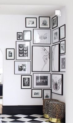 a living room with black and white checkered flooring, framed pictures on the wall