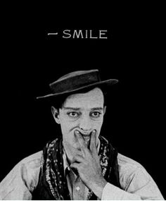 a black and white photo of a man wearing a hat with the words smile on it