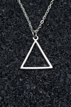 Geometric Triangle Stick Necklace is an elegant piece of jewelry that reflects elegance by combining modern design and geometric elements. This style of necklace combines minimalism and aesthetics by utilizing the triangle form. The geometric patterns and lines give the necklace a contemporary look. Geometric triangle stick necklace combines elegance and modern style, giving the wearer a unique expression. The geometric layout of the triangle adds dynamism and sophistication to the jewelry. This style necklace offers a wide range of uses from daily wear to special occasions. For those who prefer elegance without giving up simplicity, the geometric triangle stick necklace can be a special jewelry option that emphasizes your style. This necklace attracts attention with its geometric details Triangle Fashion Design, Minimalist Metal Clavicle Chain Charm Necklace, Silver Triangle Metal Necklace, Minimalist Stainless Steel Necklace With Clavicle Chain, Minimalist Stainless Steel Pendant Chain Necklace, Minimalist Triangle Metal Necklace, Minimalist Metal Pendant Chain Necklace, Minimalist Alloy Necklaces For Gifts, Modern Metal Charm Necklace With Adjustable Chain