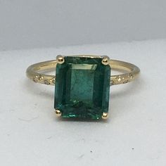 14K Yellow Gold GreenTourmaline Diamond Ring Size 7 4.40Ct Green Tourmaline measuring 10mm by 8.8mm Ring size 7 weighting 2.8 gram 8 pieces of 1mm diamonds weighting total of .04 Carat in Zigzag Pave style setting Made in Santa Monica, USA Yellow Gold Tourmaline Emerald-cut Ring, Tourmaline Rings With Gemstone Accents And Emerald Cut, Emerald Cut Tourmaline Ring With Gemstone Accents, Emerald Cut Tourmaline Jewelry With Accent Stones, Fine Jewelry Emerald Ring With Gemstone Accents, Luxury Tourmaline Ring With Center Stone, Emerald Cut Tourmaline Gemstone Rings, Formal Tourmaline Emerald Ring With Accent Stones, Emerald Cut Tourmaline Ring In Fine Jewelry Style