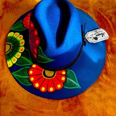 Make The Difference In Your Next Summer Vacation! Hand Painted Panama Style Hat!! Mexican Colorful Design!Painted For “Otomi “ Women’s From San Cristobal De Las Casas. Chiapas Mexico!! Size S/M Color Blue Handmade Blue Fedora With Flat Brim, Handmade Blue Wide Brim Fedora, Handmade Blue Fedora With Curved Brim, Blue Fedora One Size Fits Most For Summer, Artisan Blue Fedora Hats, Artisan Blue Fedora With Short Brim, Artisan Blue Brimmed Hat, Artisan Blue Wide Brim Fedora, Artisan Blue Flat Brim Fedora