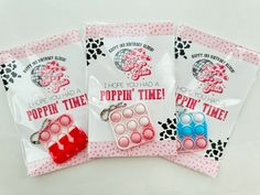 three bags of poppin't time keychains on a table