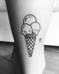 an ice cream cone with three scoops tattoo on the leg and foot is shown in black and white