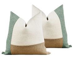 two white and brown pillows sitting next to each other