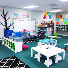 a classroom with tables, chairs and desks in the center is decorated with colorful decorations