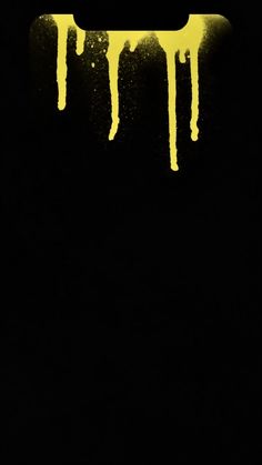 yellow dripping paint on a black background