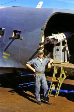 a man standing in front of an airplane with the door open and ladder up to it