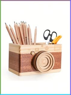 a wooden pencil holder with some scissors and other items in it, on top of a white background