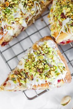 three slices of pizza on a cooling rack with pistachios and almonds