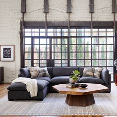 a living room filled with furniture and windows