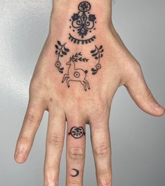 a person's hand with a tattoo on it