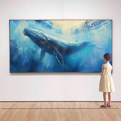 a woman in a white dress looking at a large painting on the wall behind her