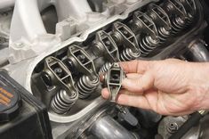 a man is working on an engine in his garage