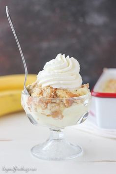 an ice cream sundae with bananas in the background