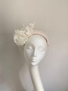 Ivory white halo crown hat Ivory white halo crown hat is made from beautiful felt fabric. In the front of the headband is matching colour netting. The headpiece has a white rubber band attached to secure it on your head, which you can hide behind your hair. There is a comb inside for extra security. This elegant and simple piece will fit any head size. It's timeless.... Enjoy your special day with this beautiful headpiece! Kristine xx to see more of my pieces visit my shop, please click the link White Headpiece, White Fitted High Crown Fascinator, White High Crown Adjustable Fascinator, Luxury White Sinamay Fascinator, Luxury White Brimmed Fascinator, Luxury White Hat Headpiece, Vintage White Hat Headpiece, Ivory Hat, White Fascinator