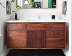 a bathroom with a wooden cabinet and mirror