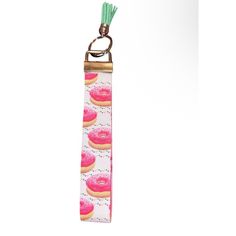 a pink and white keychain with donuts on it