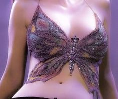 a woman wearing a purple bra top with sequins on the bottom and side