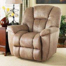 a brown recliner chair sitting on top of a carpeted floor next to a lamp