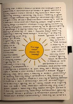 an open book with writing on it and a sun drawn on the page in yellow