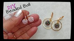 two different types of beaded balls in gold, silver and pink colors are being held by a woman's hand