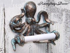 "Octopus toilet paper holder is the perfect piece for the beach bathroom. Refinished in a beautiful patina Measures 8 1/4\" Wide 7 1/2\" Tall" Goth Toilet Paper Holder, Octopus Bathroom Mirror, Toilet Paper Holder Beach Theme, Octopus Mirrors, Octopus Bathroom Decor, Octopus Bathroom, Octopus Decor, Octopus Gift, Nautical Bathroom