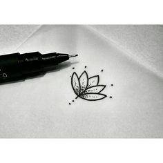 a pen is sitting on top of a piece of paper that has a drawing of a leaf