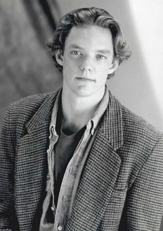 black and white photograph of a young man wearing a blazer, looking at the camera