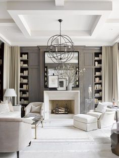 a living room filled with lots of furniture and a fire place in the middle of it