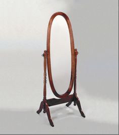 a wooden stand with a large mirror on it's top and an oval mirror on the bottom