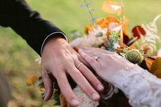 the bride and groom are holding each other's hands