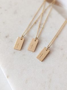 "Dainty cross necklace, 14k Gold Fill, Sterling Silver, Minimalist necklace, Cross gift, Rectangle tag, Religious, Gift for her, Faith necklace, Christian gift, Baptism gift for her, Mothers Day Gift This beautiful cross tag necklace is the perfect piece to wear everyday. PLEASE NOTE: I do not offer back stamping on any item in my shop! D E T A I L S * Gold Filled: Gold Filled Disc, Clasp and Chain. * Sterling: .925 Sterling Silver Disc, Clasp and Chain. P E N D A N T * Size: approx. 5/8\" x 5/1 Dainty Christian Jewelry, Gold Christian Jewelry, Minimalist Crucifix Charm Necklace As Gift, Minimalist 14k Gold Cross Necklace As Gift, Minimalist Personalized Cross Pendant Necklace, Gold Personalized Minimalist Cross Necklace, Gold Minimalist Personalized Cross Necklace, Minimalist Personalized Gold Cross Necklace, 14k Gold Filled Cross Charm Necklace For Gift