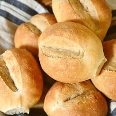 a pile of bread rolls sitting on top of a blue and white towel