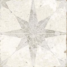 a white and gray tile with a star design on it