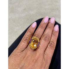 9.80 Carat Oval Cut Citrine Amethyst 14 Karat Yellow Gold Cocktail Ring!! For all you Laker lovers out there - this is perfect ring to showcase that Mamba mentality.  This magnificent ring has a bold Oval Cut Citrine that is blazing yellow! It weighs 8.35 Carats and is surrounded by 16 Yellow Sapphires and 6 Amethyst accents that weigh a total of 1.45 Carats. The total carat weight of the ring is 9.80 Carats. The ring is crafted in 14 Karat Yellow Gold and weighs approximately 6.8 grams The ring Mamba Mentality, Yellow Gold Cocktail Ring, Gold Cocktail Ring, Gold Cocktail, Yellow Sapphire, Perfect Ring, Ring Size 7, Cocktail Ring, Cocktail Rings