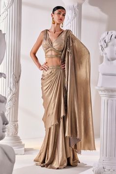 Metallic antique gold pre-draped saree. Paired with a luxurious metallic embroidered blouse with a cutout and tassel details and an embroidered tasseled belt. - Aza Fashions Fitted Gold Pre-draped Saree For Festive Occasions, Gold Pre-draped Saree With Cutdana For Party, Elegant Pre-draped Saree For Festivals, Gold Pre-draped Saree For Diwali Reception, Festive Draped Sharara For Evening, Gold Pre-draped Saree For Reception And Festive Occasions, Gold Pre-draped Saree With Cutdana In Traditional Drape, Draped Saree For Evening Festivals, Evening Saree For Festivals, Draped Style