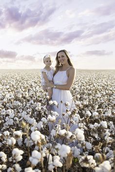 a mother and her daughter in a cotton field