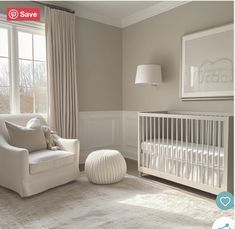 a baby's room with a crib, chair and window