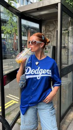 #fashion #outfits #aesthetic #blue #dodge #baggy #oversized #coffee #slickedbackhair #streetwear Sports Jersey Aesthetic, Sport Jersey Outfit Women, Jersey Outfit Ideas, Blue Outfit Aesthetic, Baseball Jersey Outfit Women, Sports Jersey Outfit, Baseball Shirt Outfit, Dodgers Outfit, Fashion Outfits Aesthetic