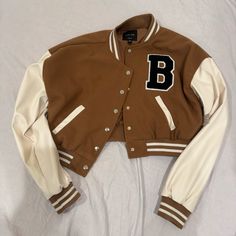 New With Tag Cheap Winter Varsity Jacket With Button Closure, Trendy Brown Varsity Jacket For College, Sporty Brown Outerwear For Spring, Brown Varsity Outerwear For Fall, Sporty Brown Spring Outerwear, Trendy Brown Varsity Jacket For Winter, Varsity Jacket Brown, Brown Varsity Jacket With Baseball Collar For Winter, Trendy Brown Long Sleeve Varsity Jacket