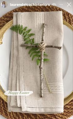 a place setting with napkins and greenery