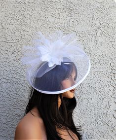 Large 14 x 11 crinoline hat with a feather flower.   The hat attaches with a clip or headband both included. You will receive in the mail 4-6 business days after purchase. Luxury White Fascinator With Curved Brim, Vintage White Fascinator Hat, Luxury White Feathered Fascinator, White Vintage Cloche Fascinator, Navy Blue Fascinator, Adjustable Hat-shaped Wedding Fascinator, White Fascinator, Blue Fascinator, Boulder City