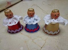 three small dolls are sitting on top of each other