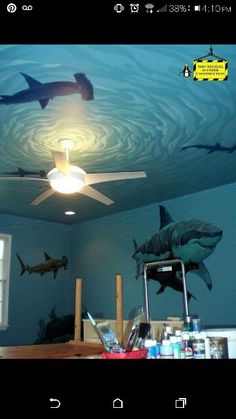 the ceiling is painted with shark images on it