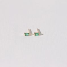 Our Emerald Baguette Stud Earrings features 0.12 carats of green emerald set in 14k yellow gold. In stock. Ships out in 48 hours. Material type 14k solid gold Stone 100% natural Emerald Gemstone Packaging Letrém logo jewelry gift box Delivery Free standard shipping 14k Gold Jewelry With Green Baguette Diamonds, Green 14k Gold Jewelry With Baguette Diamonds, Green Baguette Cut Earrings For Gifts, Baguette Cut Emerald Earrings As A Gift, Everyday Green 14k Gold Earrings, Gemstone Packaging, Baguette Studs, Emerald Set, Logo Jewelry