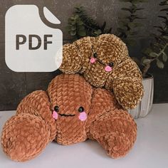 three brown teddy bears sitting next to each other on a white table with a sign that says pdf